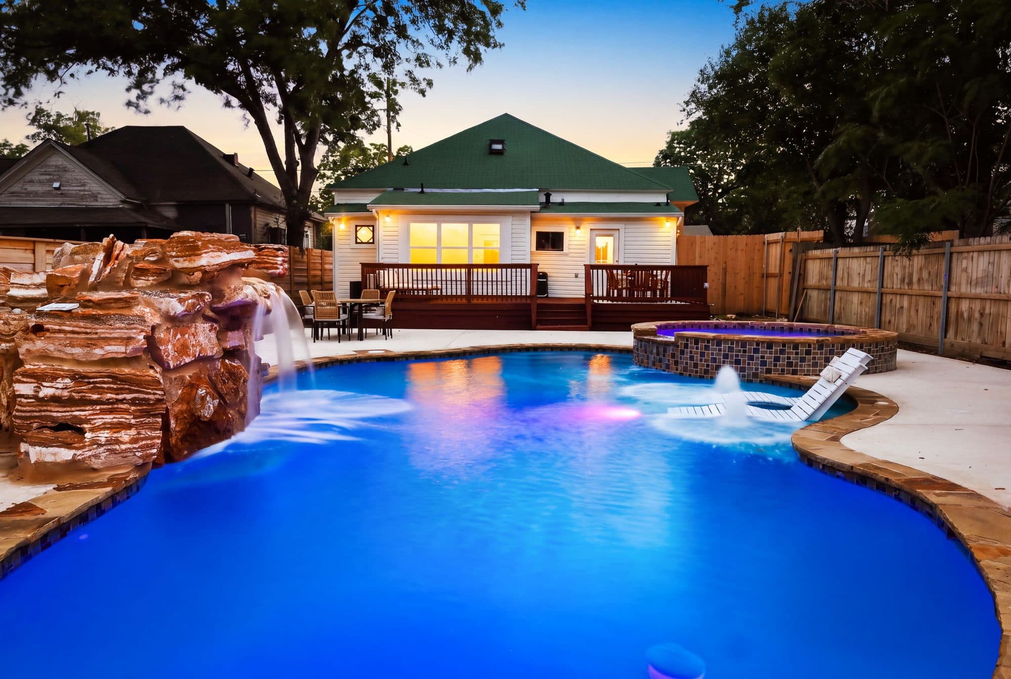 Pool and rock waterfall lit at twilight at 917 Burnet Street