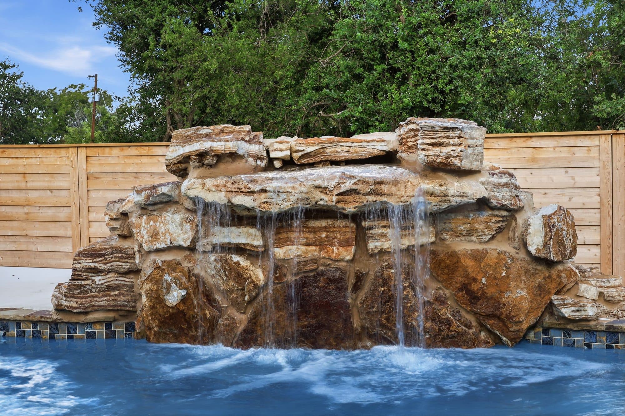 Rock waterfall feature on the pool at 917 Burnet Street