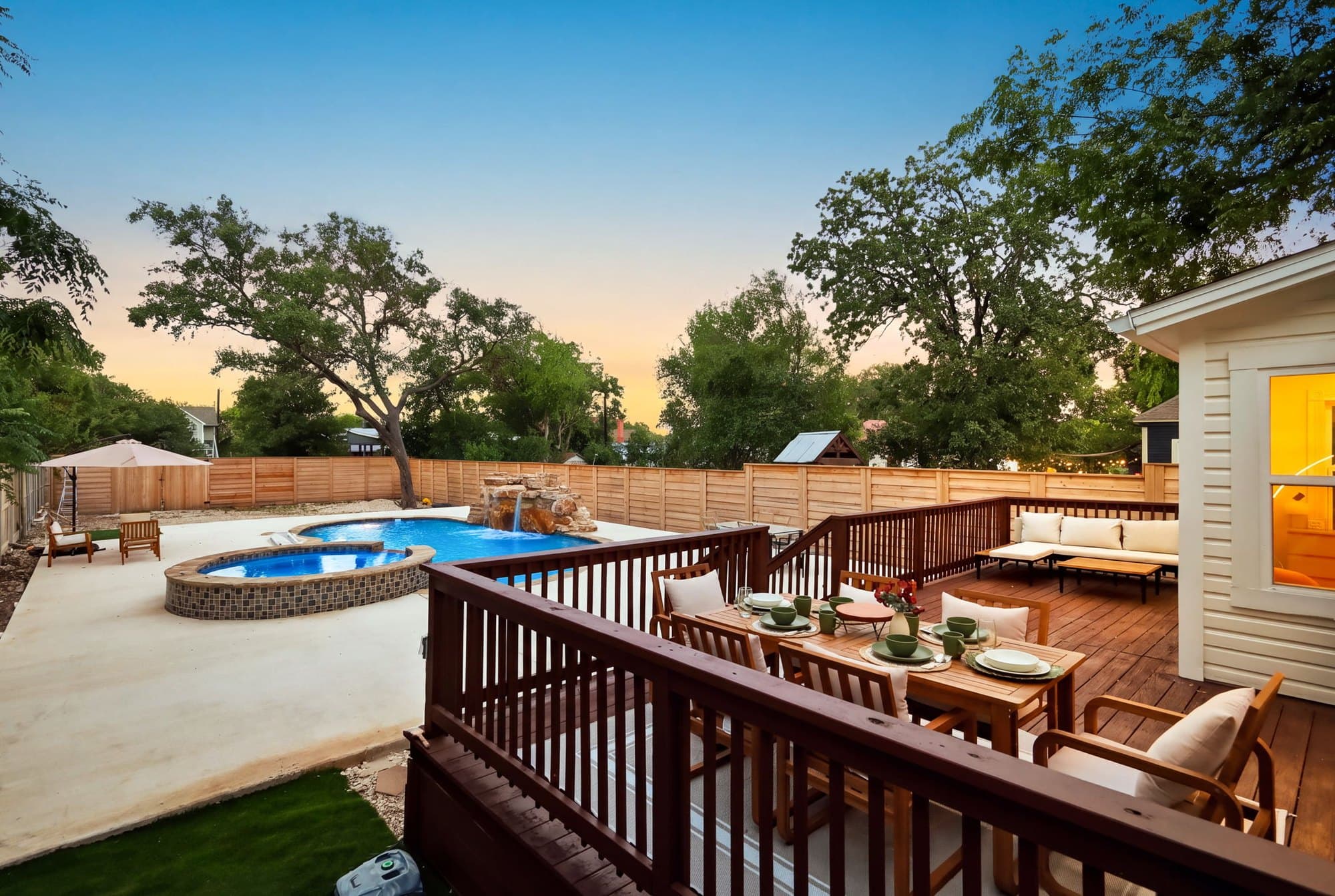 Pool and raised deck at sunset under the mature oak