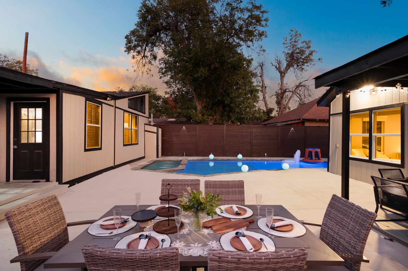 Outdoor dining table set for six beside the pool